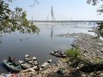A fisherman catches fish in the Yamuna River near Signature Tower, in New Delhi.