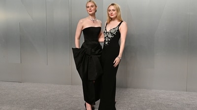 The Fanning sisters posed together in coordinating black gowns for the Vanity Fair carpet. Elle chose a luxurious black custom Givenchy gown designed by Sarah Burton, featuring a gigantic bow, while Dakota opted for a Zuhair Murad SS26 RTW ensemble, with embellishments on the torso. (Evan Agostini/Invision/AP) The Fanning sisters posed together in coordinating black gowns for the Vanity Fair carpet. Elle chose a luxurious black custom Givenchy gown designed by Sarah Burton, featuring a gigantic bow, while Dakota opted for a Zuhair Murad SS26 RTW ensemble, with embellishments on the torso. (Evan Agostini/Invision/AP)
