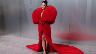 K-Pop Demon Hunters star Rei Ami looked red hot in a dramatic crimson fur gown from Quine Li. Her look featured an oversized plush fur cape enveloping her shoulders, paired with a matching floor-length skirt with a thigh-high slit and a sweeping train. (REUTERS)