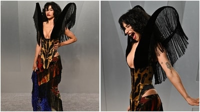 Odessa A'zion's Harris Reed ensemble stole the spotlight at the Vanity Fair Oscar Party. She opted for a theatrical look with a tiger-print corset bodice and high-cut sides, paired with a patchwork skirt of vibrant fabrics and fringe, finished with towering black fringed shoulder structures. (Evan Agostini/Invision/AP) Odessa A'zion's Harris Reed ensemble stole the spotlight at the Vanity Fair Oscar Party. She opted for a theatrical look with a tiger-print corset bodice and high-cut sides, paired with a patchwork skirt of vibrant fabrics and fringe, finished with towering black fringed shoulder structures. (Evan Agostini/Invision/AP)