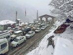 Tourist vehicles stand stuck in traffic amid fresh snowfall at Atal Tunnel Rohtang near Manali, in Kullu on Monday.