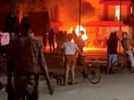 Anti-government protesters look on as a fire burns at a Communist Party office in Moron, Cuba, in this screengrab from video released over the weekend.