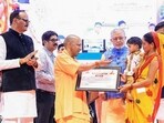 Chief minister Yogi Adityanath during the transfer of the first instalment of grants to the bank accounts of 90,000 beneficiaries under the Pradhan Mantri Awas Yojana, in Lucknow on Monday. (@myogiadityanath)