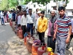 People standing in long queues, waiting for LPG delivery, in Gomti Nagar in Lucknow on Monday. 