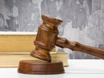 Wooden gavel and books on wooden table