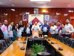 CM Pushkar Singh Dhami releases the Uttarakhand Secretariat Badminton Club souvenir “Prayas Behtar Kal Ke Liye” in Dehradun on Tuesday.