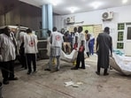 Members of the Nigerian Red Cross carry body bags containing casualties at a Maiduguri hospital following explosions that struck the northeastern city of in Nigeria