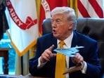 President Donald Trump holds a model of a B-2 stealth bomber as he speaks after signing an executive order in the White House