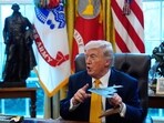 President Donald Trump holds a model of a B-2 stealth bomber as he speaks after signing an executive order in the White House