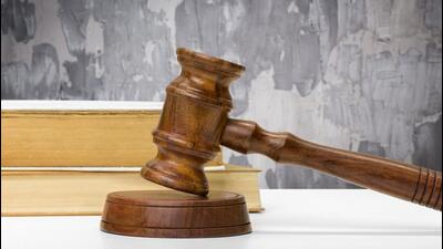 Wooden gavel and books on wooden table Wooden gavel and books on wooden table