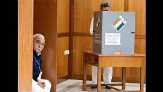 Haryana Congress Legislature Party (CLP) leader and former chief minister Bhupinder Singh Hooda looking on as Panchkula MLA and ex-deputy CM Chander Mohan casts his vote for the Rajya Sabha election in Chandigarh on Monday. (Keshav Singh/HT)