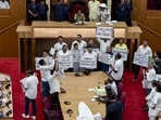 BJD MLAs stage a protest against the state health department during the budget session of the Odisha assembly on Wednesday. (PTI)