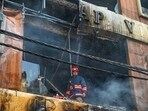 Firefighters attempt to douse a massive fire that gutted a building in Sadh Nagar near Palam in New Delhi. 