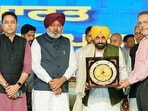 Punjab CM Bhagwant Mann being felicitated during a public meeting in the grain market of the Dhuri constituency, in Sangrur on Tuesday. (ANI)
