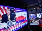 A television station broadcasts President Donald Trump on the floor of the New York Stock Exchange, New York, Monday.