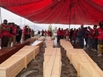 Coffins containing the remains of victims of a Monday airstrike on a drug rehabilitation hospital are laid out before burial in Kabul