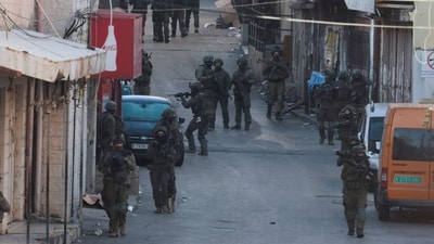 Israeli soldiers take position during a raid, in Ramallah, in the Israeli-occupied West Bank March 17. (Reuters)