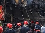 Firefighters attempt to douse a massive fire that gutted a building in Sadh Nagar near Palam in New Delhi on Wednesday.