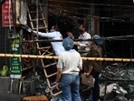 Forensic officials inspect the site of the fire. (Vipin Kumar/HT Photo)