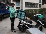 Hamza Hareb, who works as a delivery driver for the Toters delivery app opens his courier's backpack to drop a delivery in Beirut, Lebanon, March 18, 2026.