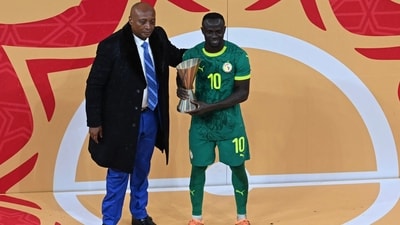 CAF President Patrice Motsepe stands next to Senegal's Sadio Mane with the Man of the Competition award after the AFCON final. (AFP) CAF President Patrice Motsepe stands next to Senegal's Sadio Mane with the Man of the Competition award after the AFCON final. (AFP)