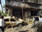Police personnel and people gather as a rescue operation is underway after a fire broke out in a house in Indore, Madhya Pradesh, on Wednesday. (PTI)