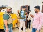 Punjab Anti-Gangster Task Force (AGTF) superintendent of police Bikramjit Singh Brar (in cap) after the encounter in Kaithal district of Haryana on Thursday. (HT Photo)