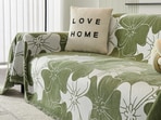 A living room styled with floral sofa covers and bright cushions that instantly bring a breezy summer mood into the home.