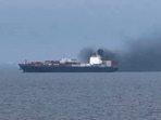 This frame grab from handout UGC video footage by seafarer Wang Shang taken on March 12, 2026 and released to AFPTV on March 13 shows smoke emerging from the Source Blessing cargo vessel, as filmed from the vessel Wang was onboard in the Gulf, north of Dubai.  (Source: AFP PHOTO /WANG SHANG/UGC via AFPTV/HANDOUT)
 