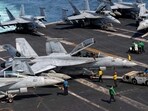 US sailors taxiing an F/A-18F Super Hornet, attached to Strike Fighter Squadron (VFA) 41, on the flight deck aboard Nimitz-class aircraft carrier USS Abraham Lincoln (CVN 72), in support of Operation Epic Fury, on March 17, 2026.
