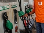 A petrol pump attendant picks up a nozzle to refuel a vehicle at an Indian Oil fuel station 