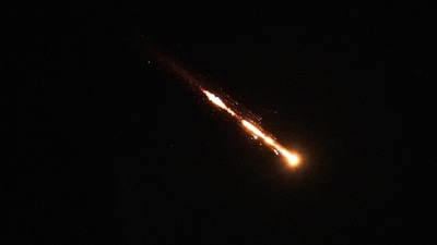 Trails of a cluster missile fired from Iran cross the sky over Tel Aviv, Israel, Wednesday. (AP) Trails of a cluster missile fired from Iran cross the sky over Tel Aviv, Israel, Wednesday. (AP)
