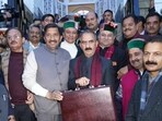 Chief minister Sukhvinder Singh Sukhu along with his deputy Mukesh Agnihotri and Congress legislators at the Himachal Pradesh Vidhan Sabha in Shimla before presenting the budget on Saturday. (Deepak Sansta/HT)