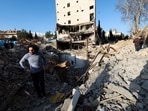 A man stands in the middle of the rubble left of a building that was destroyed by a strike, amid the U.S.-Israeli conflict with Iran, in Tehran, Iran.