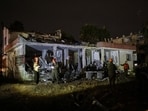 Israeli soldiers attend the scene of damage caused after Iranian missile barrages struck Dimona.
