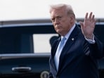 President Donald Trump waves after landing at Palm Beach International Airport on March 20, 2026.