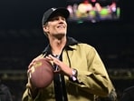 Former NFL player Tom Brady on the pitch before the match 