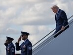 President Donald Trump walks down to the tarmac from Air Force One on March 20, at the Palm Beach International Airport in Florida, where he spends his weekends.