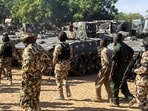 Nigerian soldiers walks past military tanks prepared for deployment during a tour of the Theatre Command Operation Lafiya Dole by Nigeria's Chief of Army Staff at Maimalari Cantonment in Maiduguri, Borno State. 
