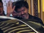 Vijay's fan waved TVK flags and cheered as they waited to catch a glimpse of him. 