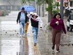 Visitors caught in the rain at the Sector 17 Plaza in Chandigarh on Friday. (Keshav Singh/HT)