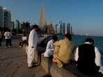 People sit along the Corniche on the second day of Eid al-Fitr celebrations, marking the end of the Muslim holy month of Ramadan, in Doha.