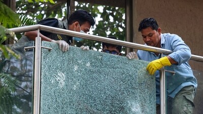 Forensic team members remove a shattered glass pane from the balcony of filmmaker Rohit Shetty after unidentified persons opened fire at his multi-storey residence, at Juhu. (PTI Photo) (PTI) Forensic team members remove a shattered glass pane from the balcony of filmmaker Rohit Shetty after unidentified persons opened fire at his multi-storey residence, at Juhu. (PTI Photo) (PTI)