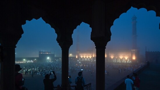 People gather to offer prayers during a foggy morning at Jama Masjid on the occasion of Eid in New Delhi.&nbsp;(Raj K Raj/HT Photo)