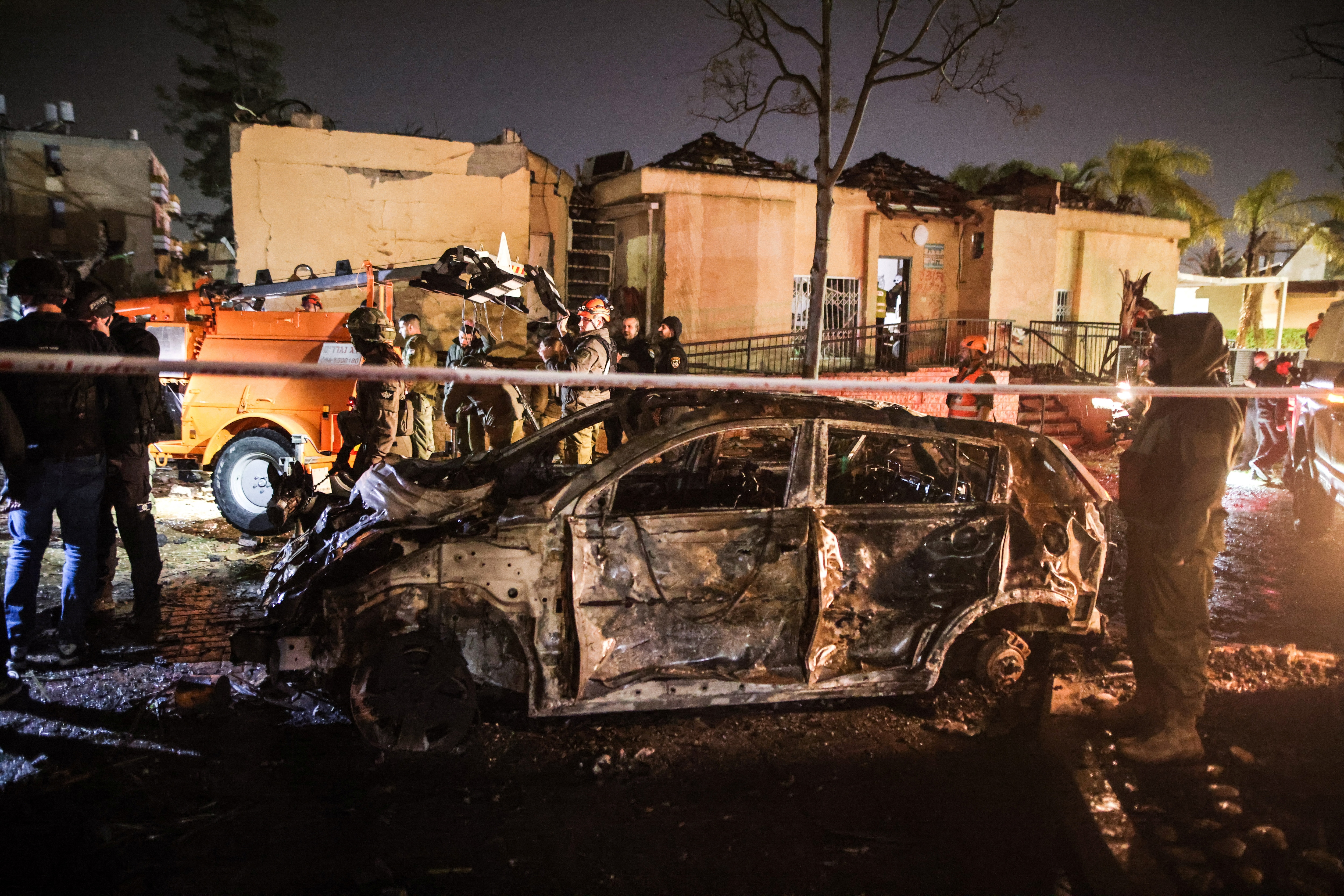 Emergency response personnel work at the site of damage after Iranian missile barrages struck Dimona, amid the U.S.-Israel conflict with Iran, in southern Israel (Reuters)