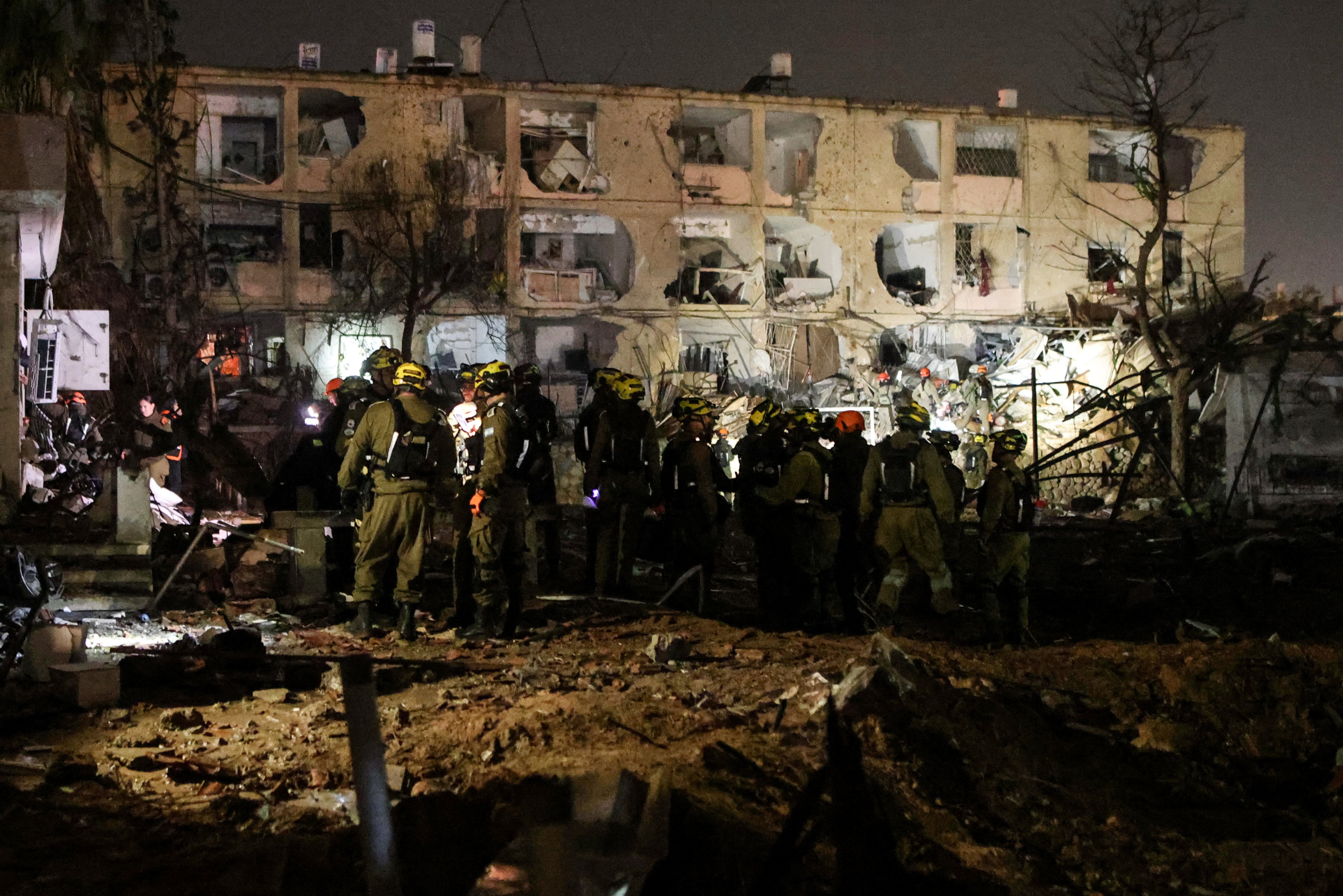 Israeli soldiers work at the scene of damage after Iranian missile barrages struck Dimona, amid the U.S.-Israel conflict with Iran, in southern Israel (Reuters)