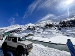 A vehicle parked at a snow-covered area near the North Portal of Atal Tunnel, Lahaul and Spiti, on Sunday. (PTI)
