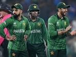 Pakistan's captain Salman Agha (R) claps as Paksitan players watch on during the T20 World Cup.