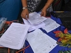 Election Commission officials assist voters at a help desk camp for the Special Intensive Revision (SIR) of Electoral Rolls, in Sonagachi, Kolkata.