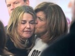 Savannah Guthrie, left, gets a kiss form Hoda Kotb during a visit to the Today show at Rockefeller Plaza on Thursday
